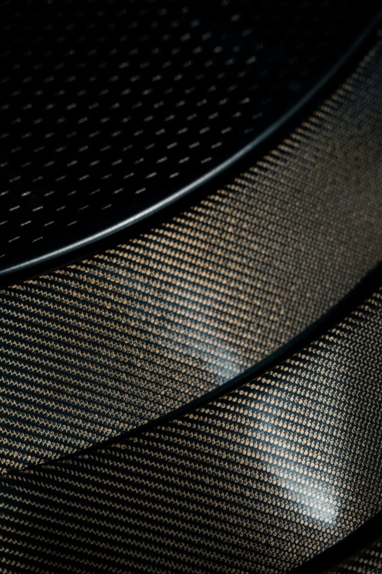 Close-up of carbon fiber texture — similar strength and stiffness achieved with PA-CF 3D printed parts