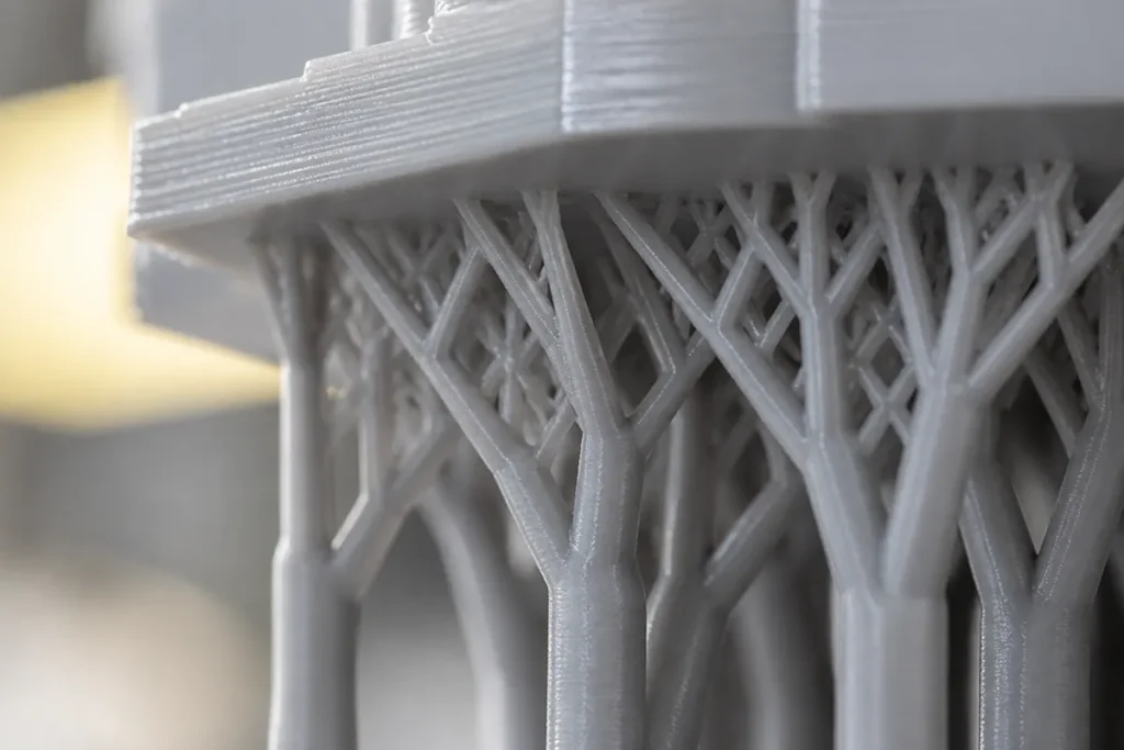 Tree supports on a 3D print, the kind a dedicated support filament removes cleanly.