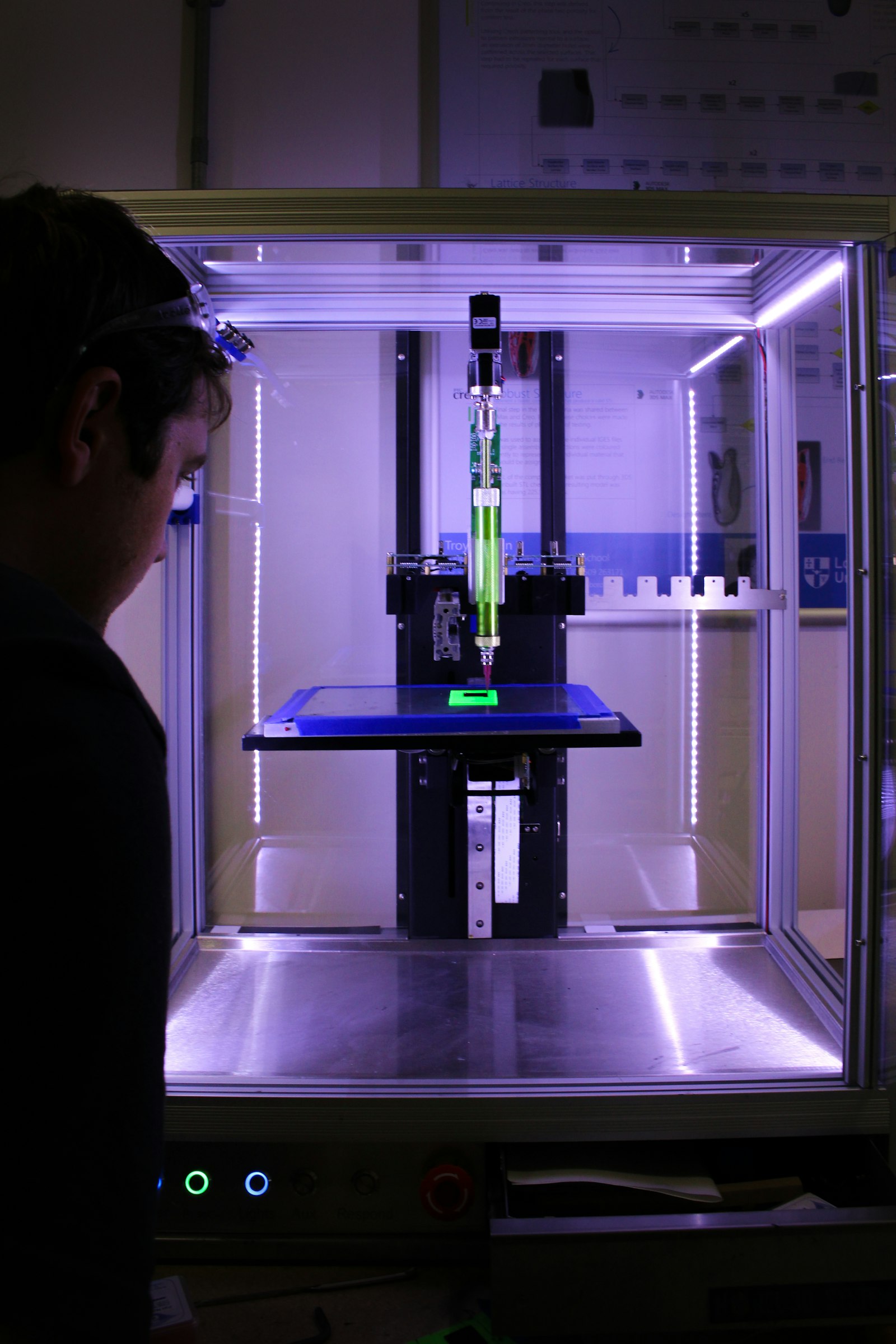 Person working beside a desktop 3D printer while preparing a custom filament profile