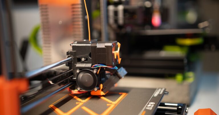 3D printer extruding filament close-up — outdoor-ready filament guide for Bambu Lab