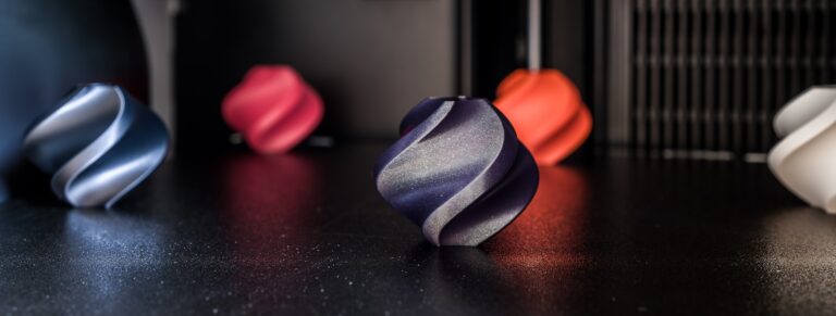 Best glow in the dark filament — colorful 3D printed models on a desk