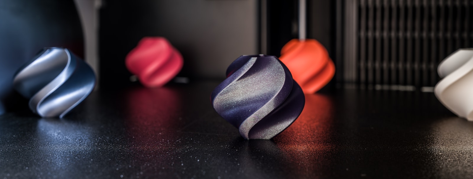 Best glow in the dark filament — colorful 3D printed models on a desk
