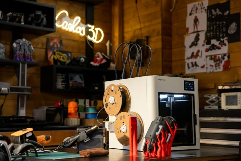 Best PLA filament for Bambu A1 Mini — 3D printer with PLA filament spools and printed objects